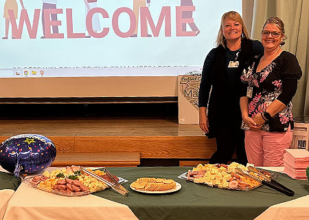 photo: two women at buffet table