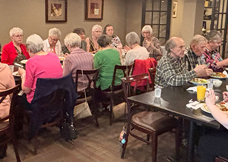 photo: group of elders dining in restaurant