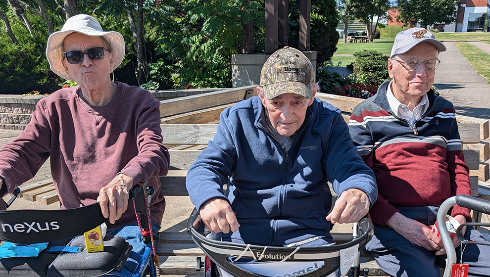photo: three elderly men sitting in park