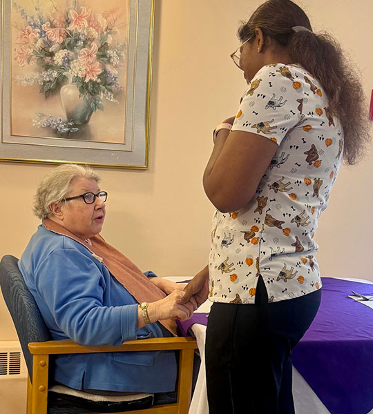 photo: employee comforting elderly woman
