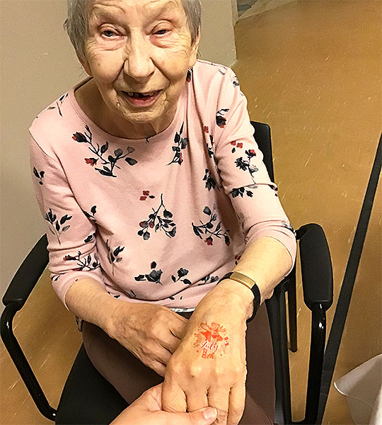 photo: elderly woman offering her hand