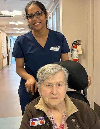 photo: female staff with elder woman in wheelchair