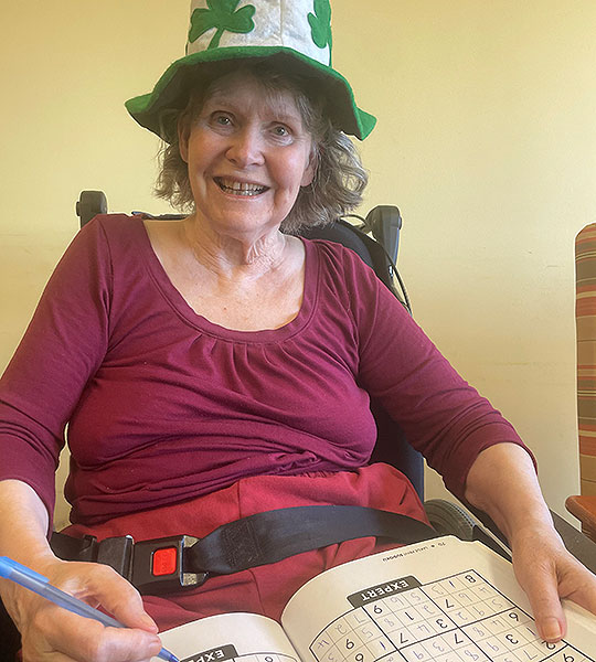 photo of elderly woman doing sudoku puzzle